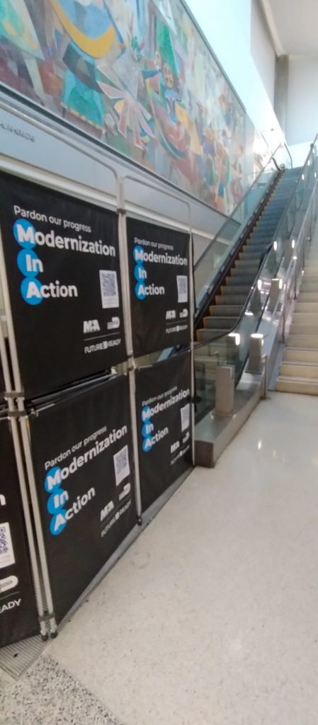 Escalators out of service with a sign saying we're working to provide better service.